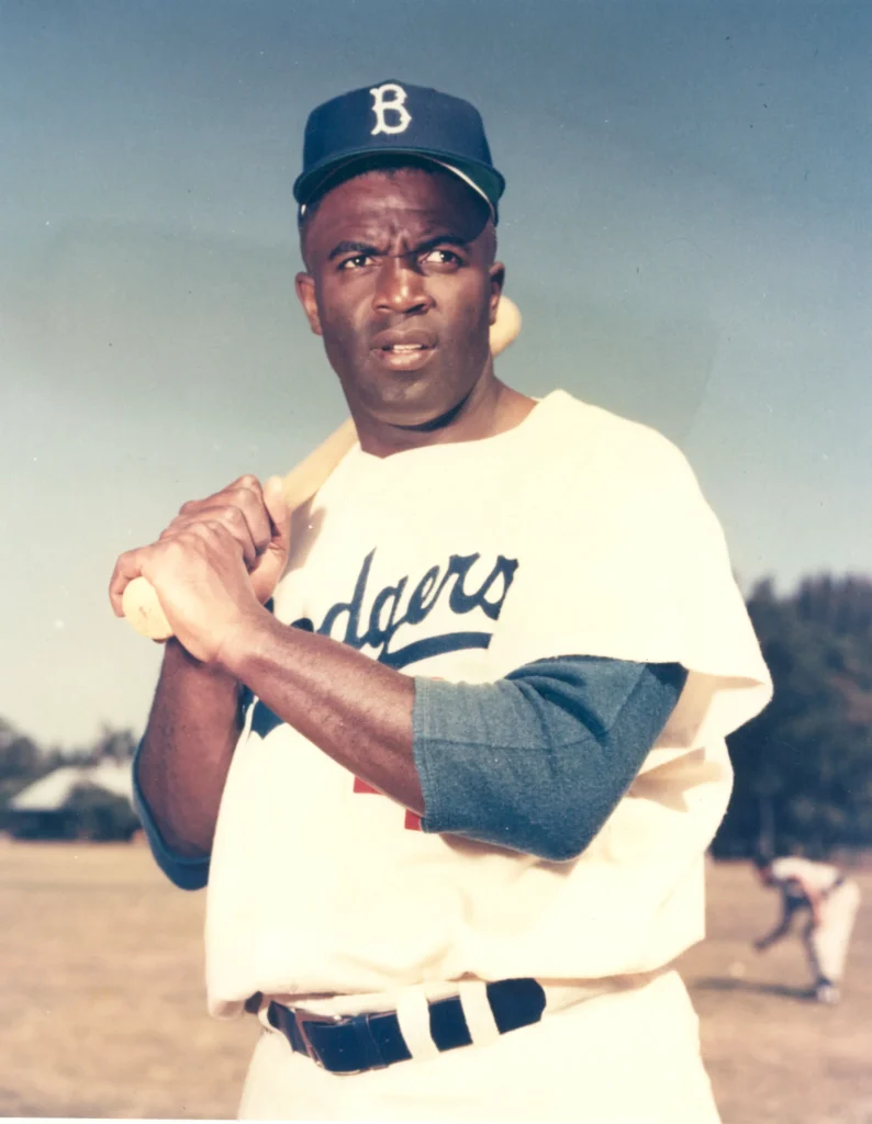 Jackie Robinson wearing a Brooklyn Dodgers uniform, holding a bat
