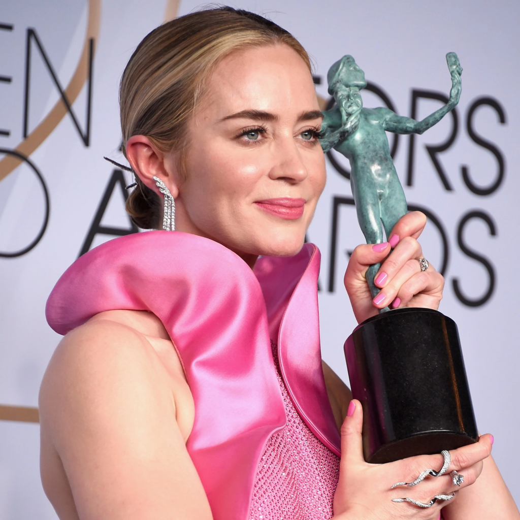 Emily Blunt holding her SAG award