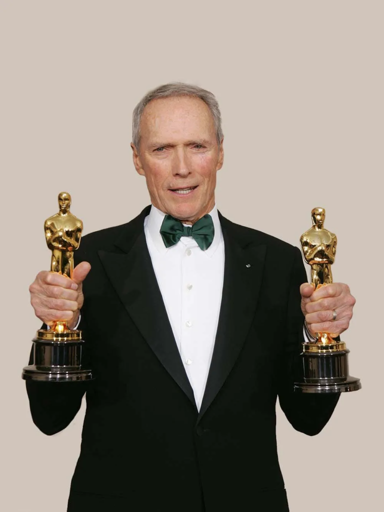 Clint Eastwood posing with his Oscars at the 77th Academy Awards in 2005