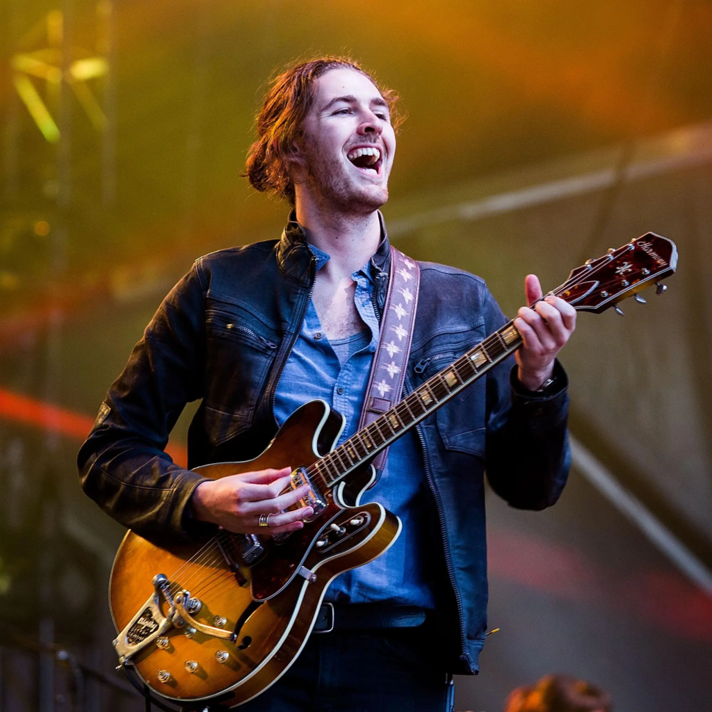Hozier singing and playing the guitar