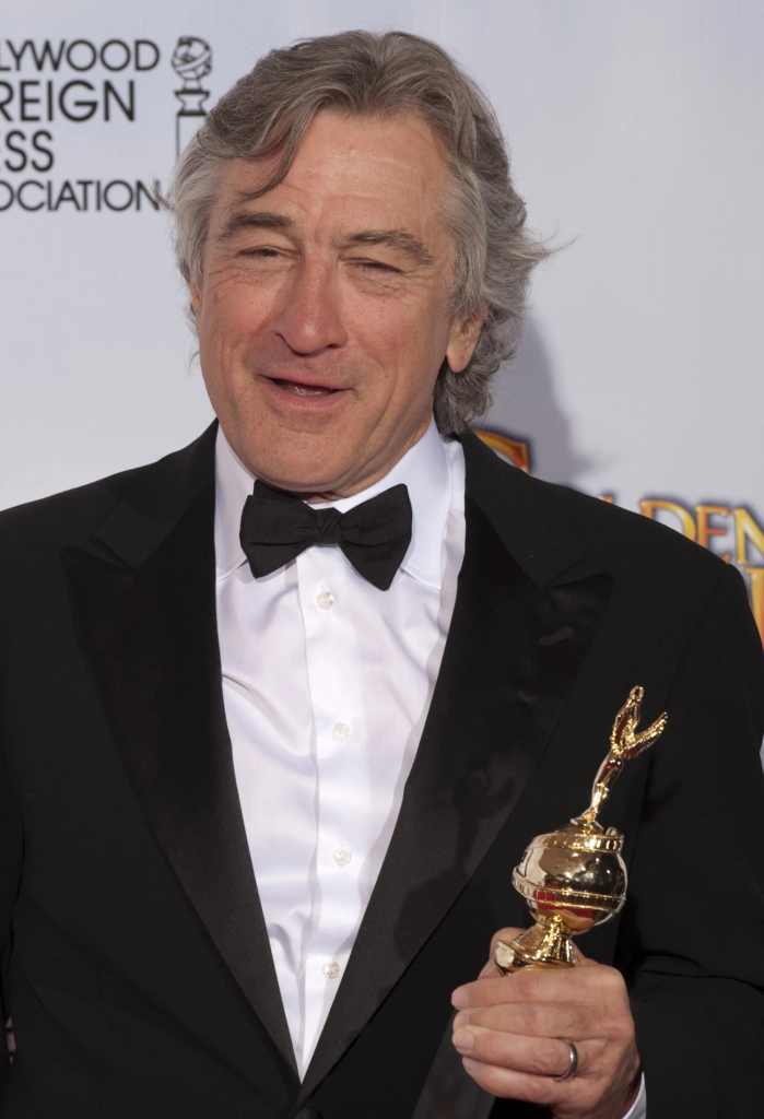 Robert De Niro holding his Golden Globe award