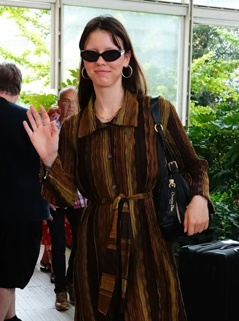 Mia Goth waving