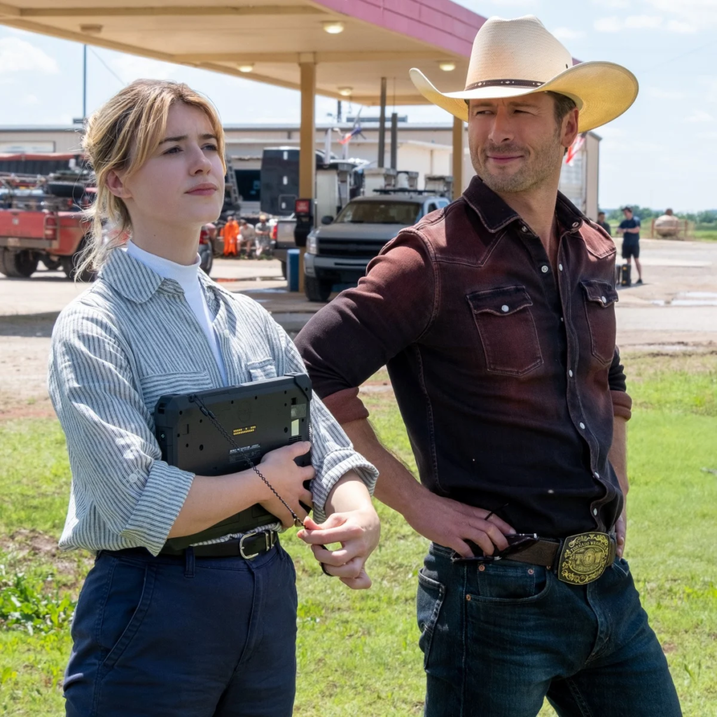 photo from the set of the 2024 film Twisters, featuring actors Daisy Edgar-Jones and Glen Powell.