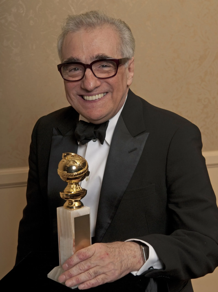 Martin Scorsese holding his Golden Globe award