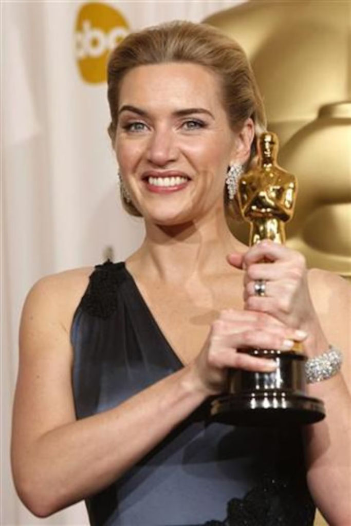 Kate Winslet holding her Academy Award