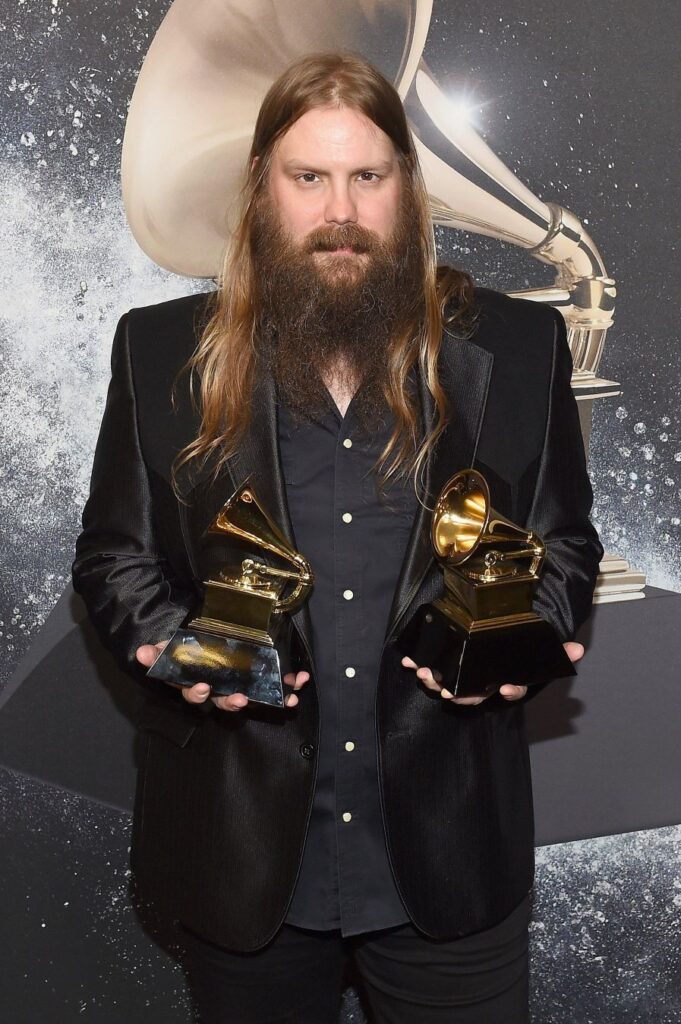 Chris Stapleton posing with two awards at the 60th Annual Grammy Awards in 2018