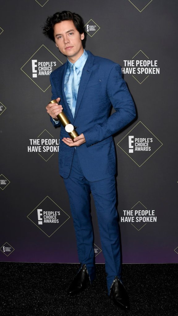Cole Sprouse posing on the red carpet at the 45th E! People's Choice Awards in 2019