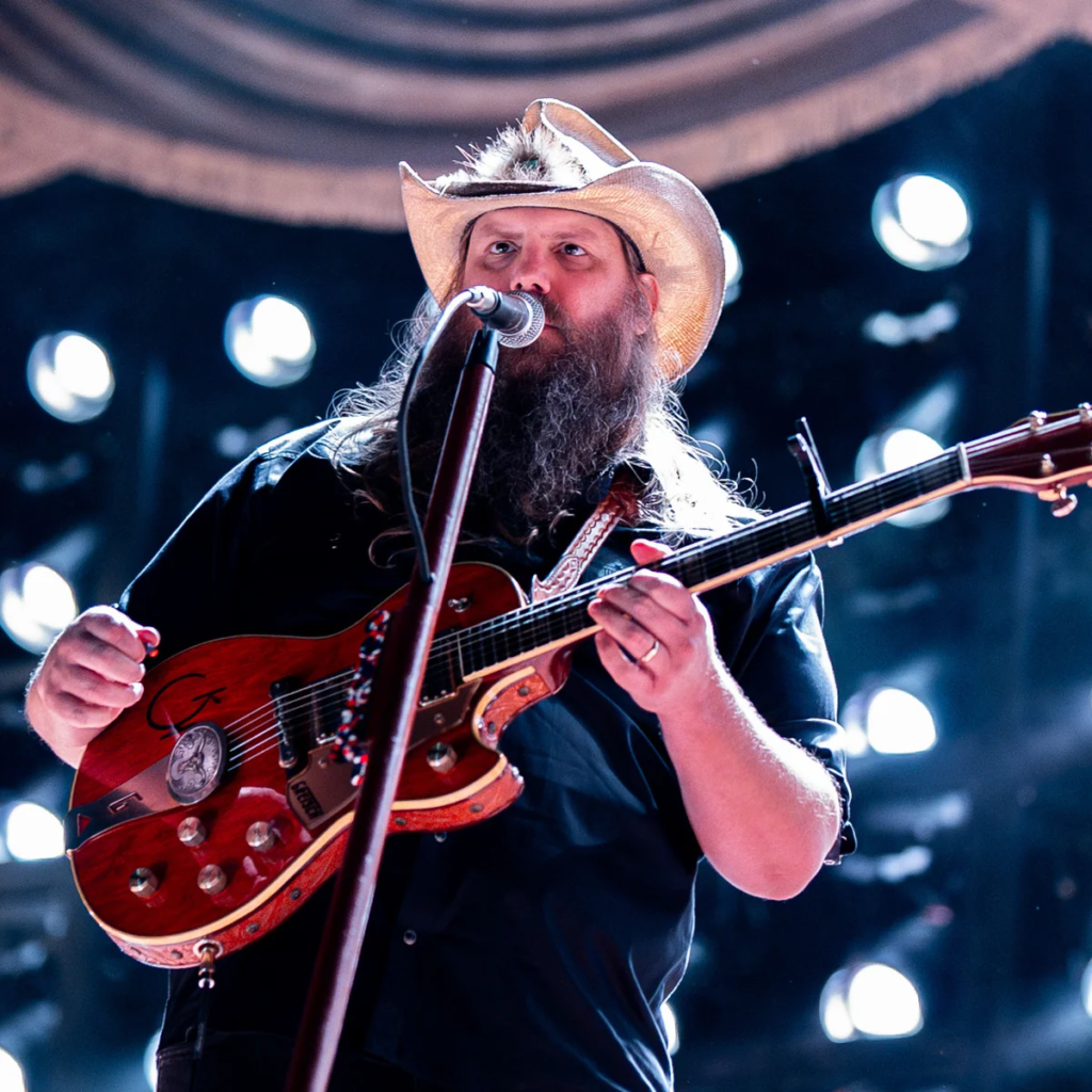 Chris Stapleton performing live on stage with his guitar