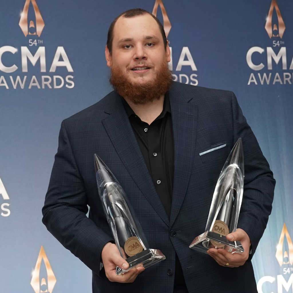 Luke Combs holding two awards at the 54th CMA Awards in 2020