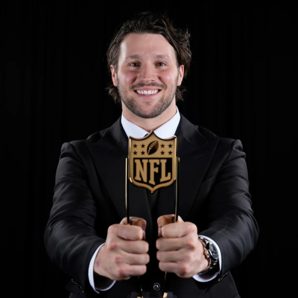 Buffalo Bills quarterback Josh Allen holding the Associated Press NFL Most Valuable Player award at the 2024 NFL Honors ceremony