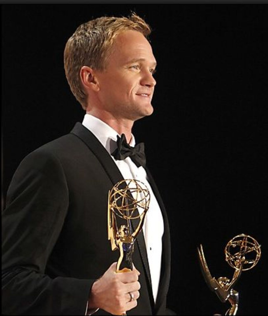 Neil Patrick Harris holding two Emmy Award trophy at the Primetime Emmy Awards