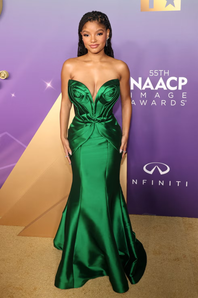 Halle Bailey in a bespoke emerald green mermaid gown by Nicole + Felicia at the 55th NAACP Image Awards in March 2024