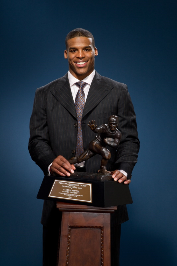 Cam Newton holding the Heisman Memorial Trophy after winning it on December 11, 2010