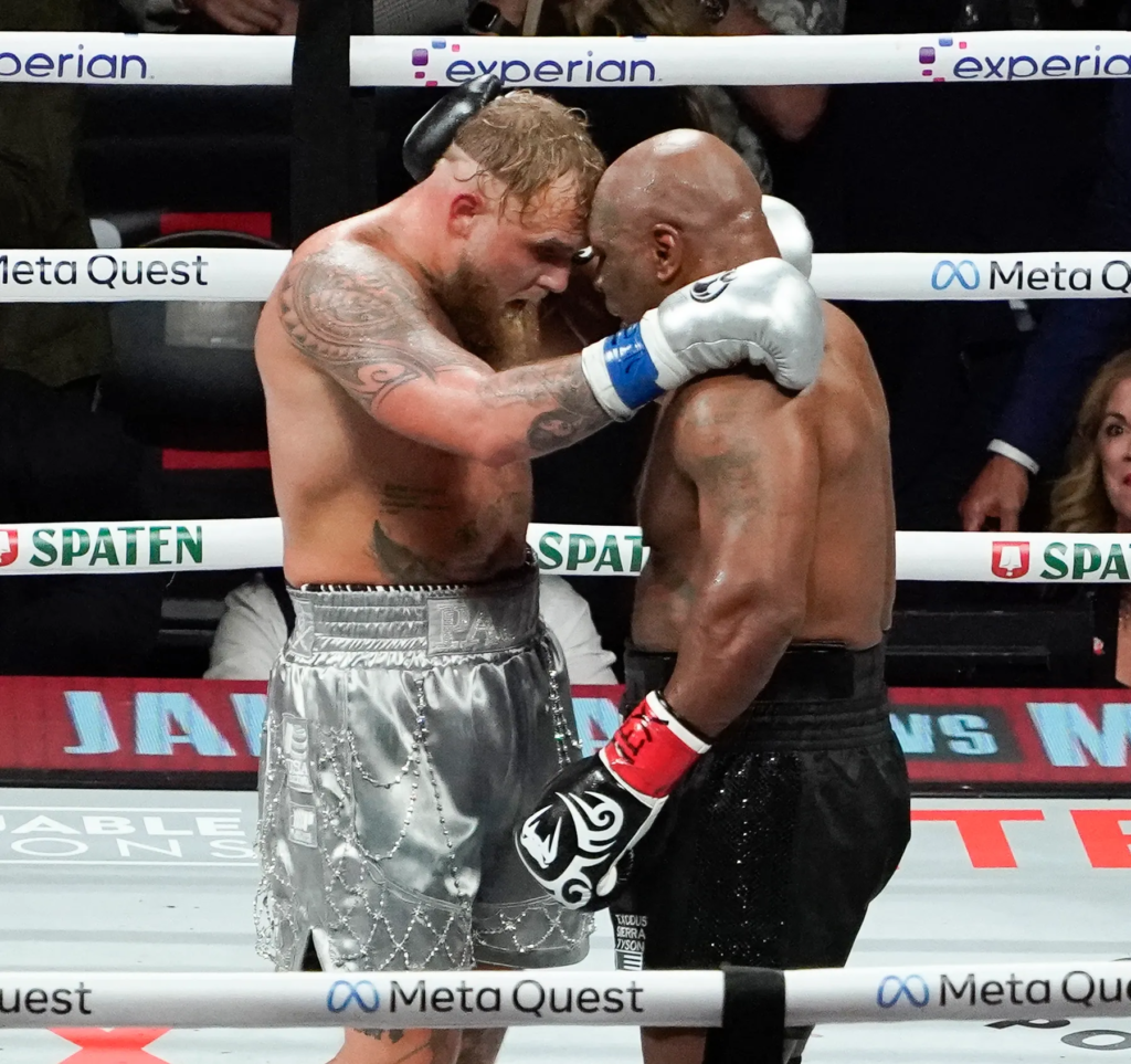 a moment during the professional boxing match between YouTuber-turned-boxer Jake Paul and former undisputed heavyweight champion Mike Tyson, held on November 15, 2024, at AT&T Stadium in Arlington, Texas