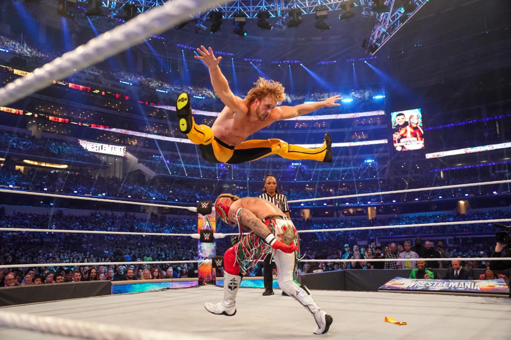 a moment from WrestleMania 38 in April 2022, featuring social media star Logan Paul performing an acrobatic move