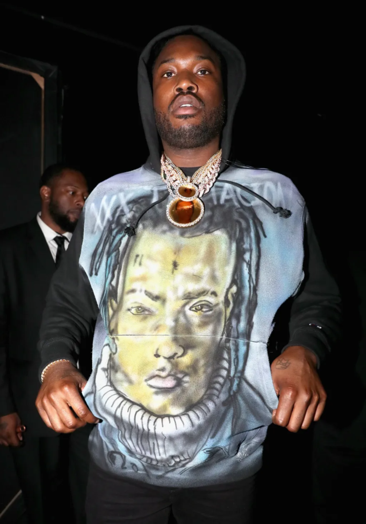 Meek Mill wearing a custom hoodie featuring a tribute portrait of the late rapper XXXTentacion during the 2018 BET Awards