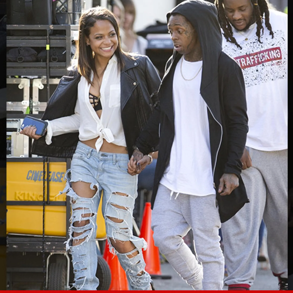 Lil Wayne and Christina Milian holding hands
