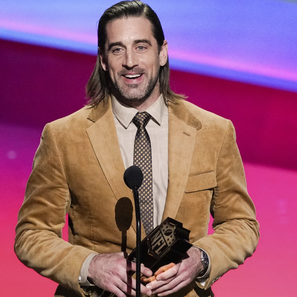 professional football player Aaron Rodgers accepting an award on stage