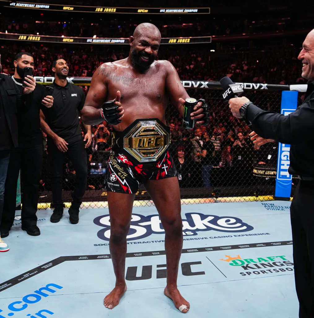 Jon Jones celebrating his victory at UFC 309, where he successfully defended his heavyweight title against Stipe Miocic