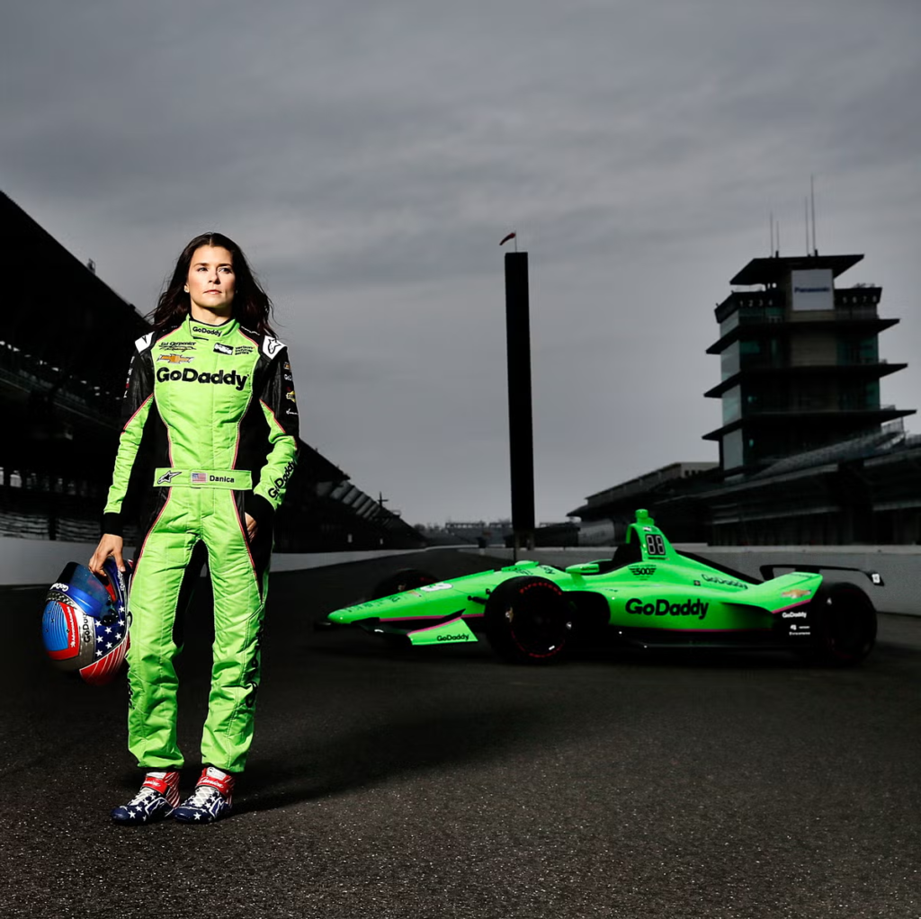 Danica Patrick posing with her GoDaddy-sponsored Ed Carpenter Racing Chevrolet for the 2018 Indianapolis 500