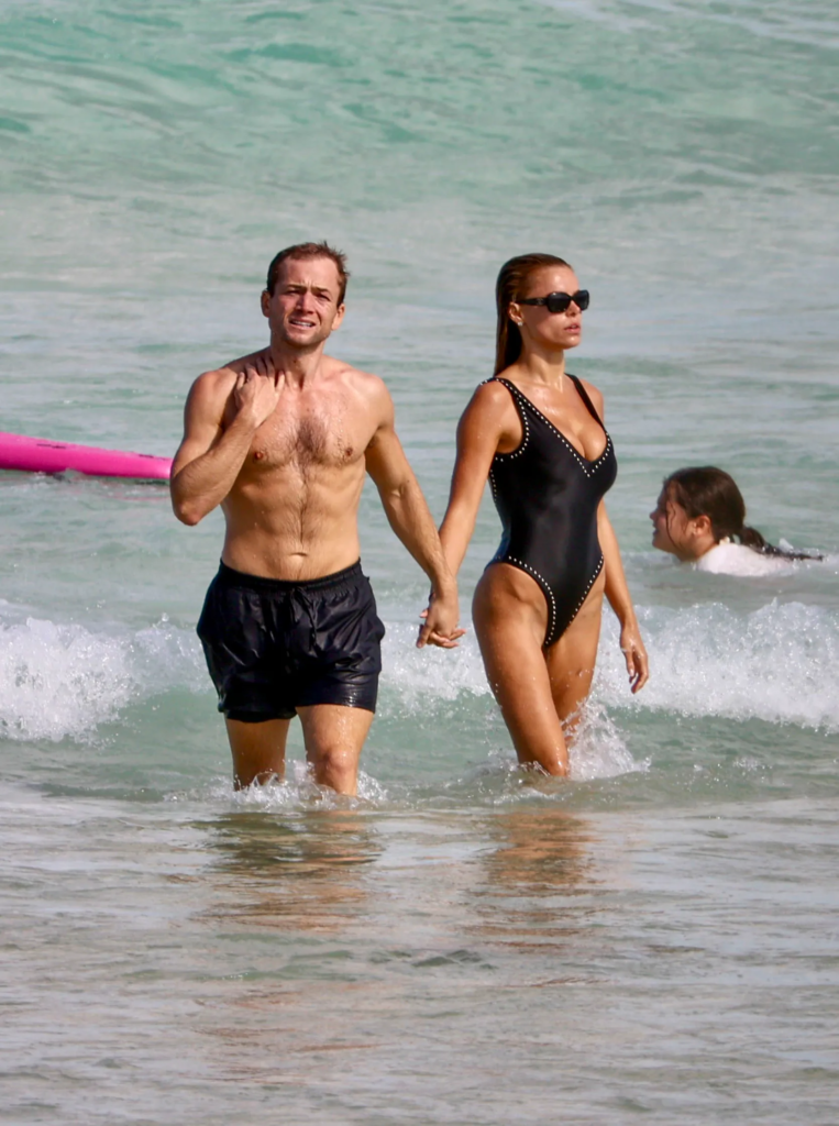 Taron Egerton and Brooks Nader at the beach