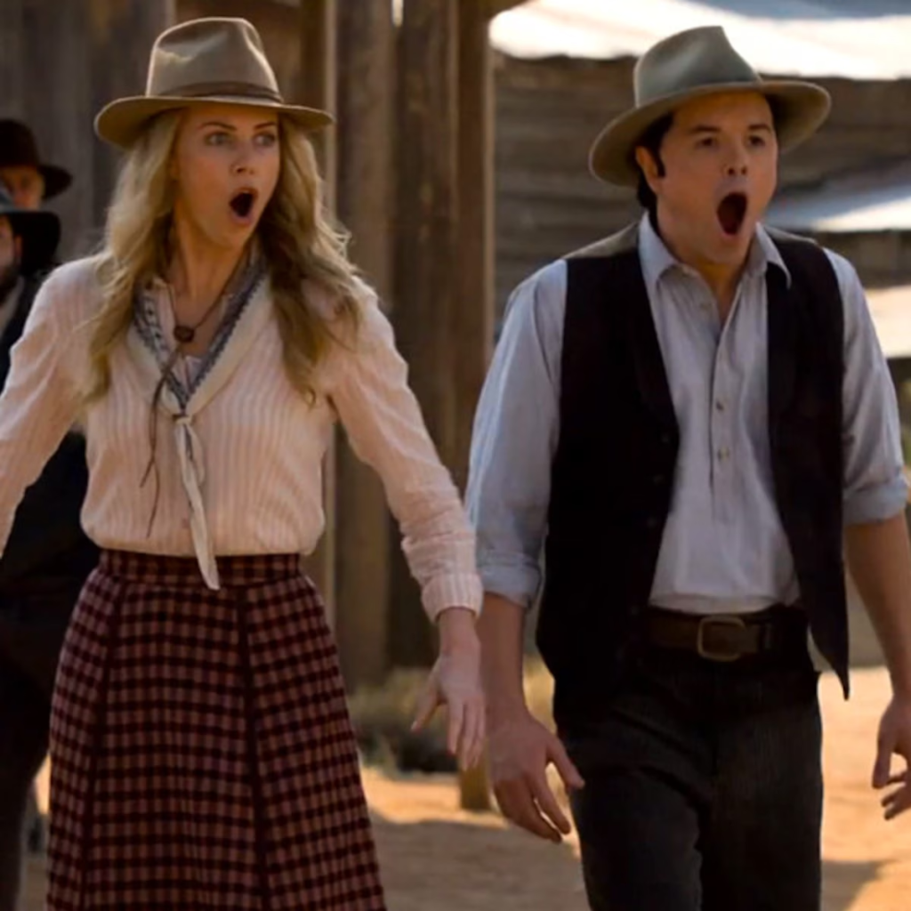 a scene from the 2014 comedy film A Million Ways to Die in the West, featuring Charlize Theron as Anna Barnes-Leatherwood and Seth MacFarlane as Albert Stark