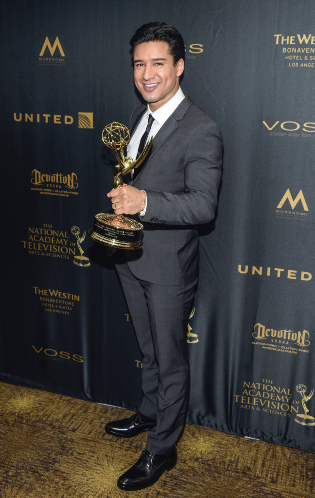 Mario Lopez posing with an Emmy award at the 43rd annual Daytime Emmy Awards in 2016