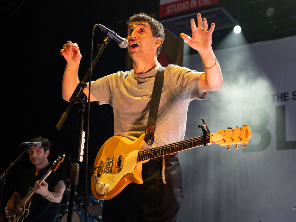 Jack Antonoff is shown performing live with his band Bleachers