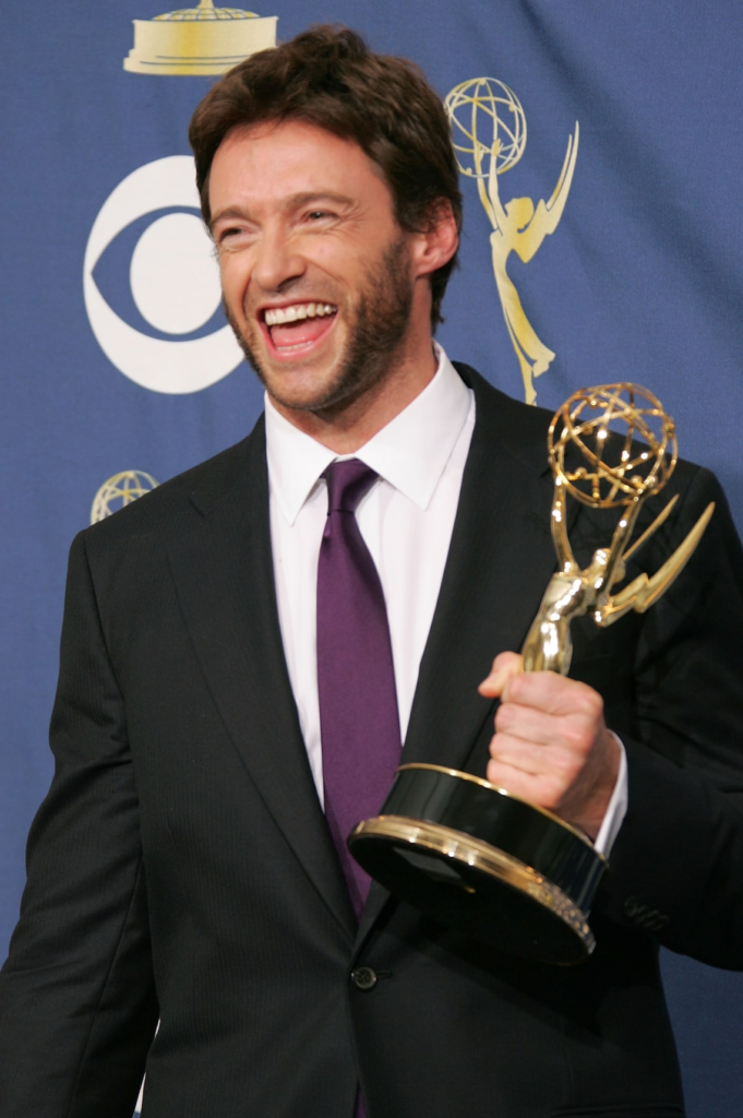 Hugh Jackman holding an Emmy Award