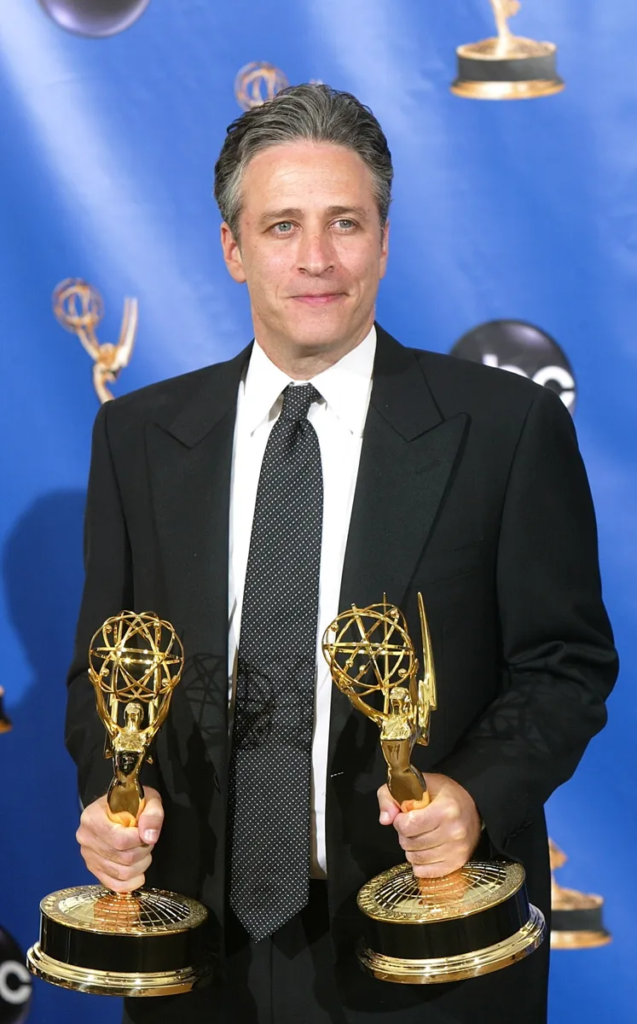 Jon Stewart holding two Emmy awards at the 57th Annual Primetime Emmy Awards on September 18, 2005