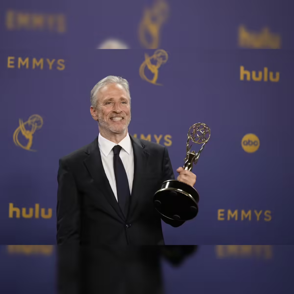 television host and comedian Jon Stewart holding an Emmy award, from his 2024 win for The Daily Show