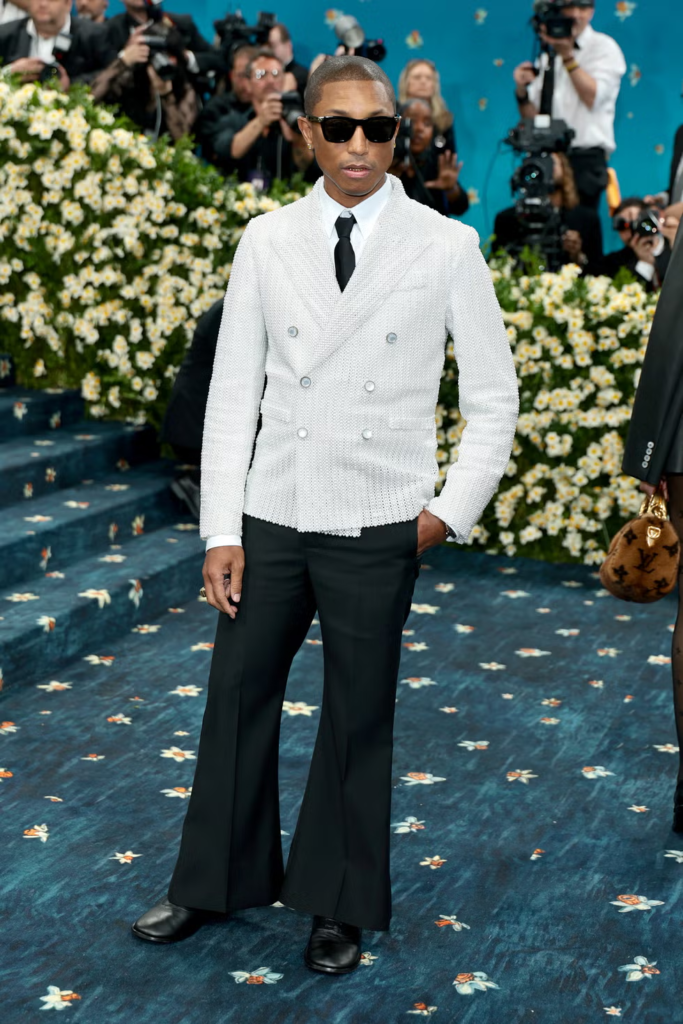 Pharrell Williams attended the 2025 Met Gala as a co-chair, wearing a custom pearl-covered jacket designed by himself and brought to life by the Louis Vuitton design team