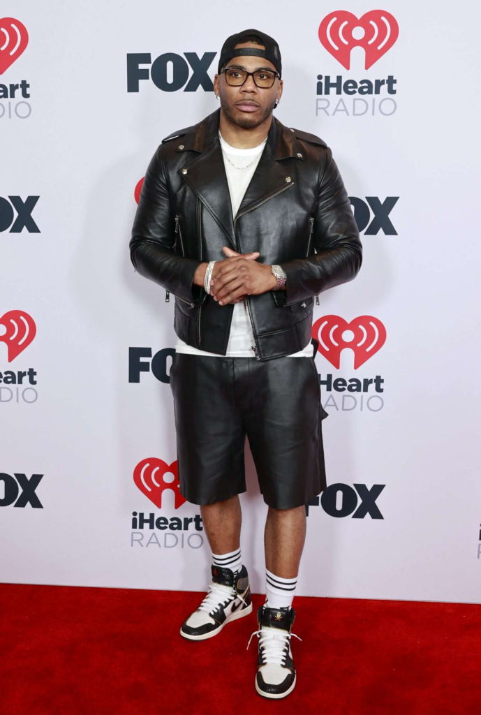 Nelly at the 2021 iHeartRadio Music Awards wearing a leather jacket and matching shorts