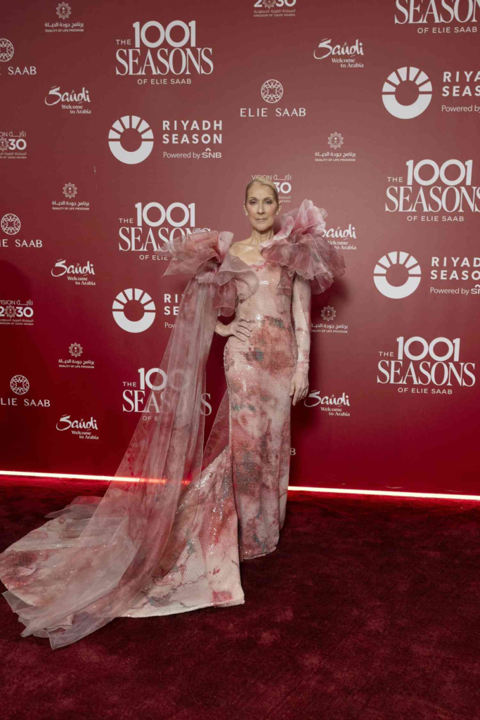 Celine Dion wearing a custom rose-hued Elie Saab gown with dramatic tulle sleeves at "The 1001 Seasons of Elie Saab" show in Riyadh