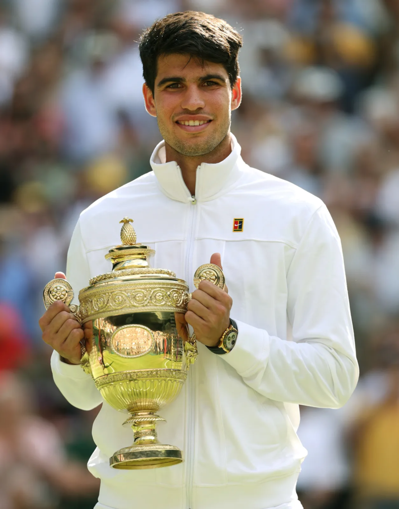 Carlos Alcaraz wearing a white Nike jacket while celebrating his win at the 2024 Wimbledon Championships