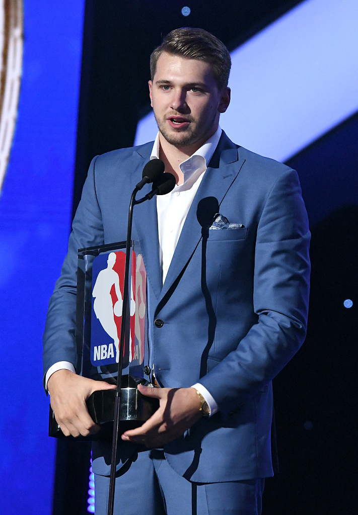 Luka Dončić is pictured holding the NBA Rookie of the Year trophy at the 2019 NBA Awards
