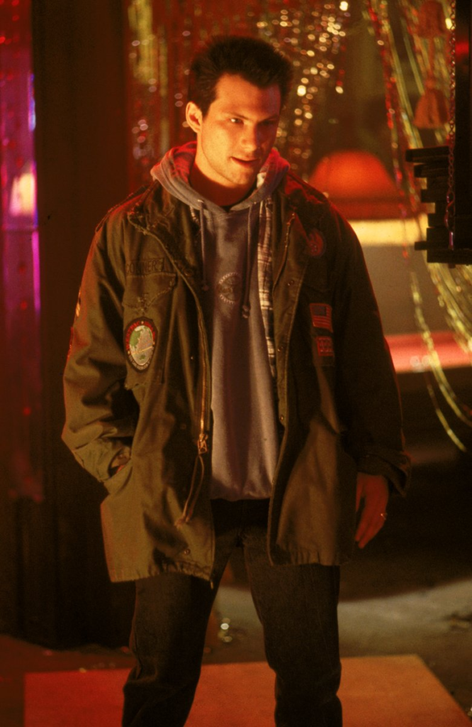 Christian Slater as Clarence Worley in the 1993 film True Romance, wearing an iconic olive green M-65 field jacket decorated with various patches