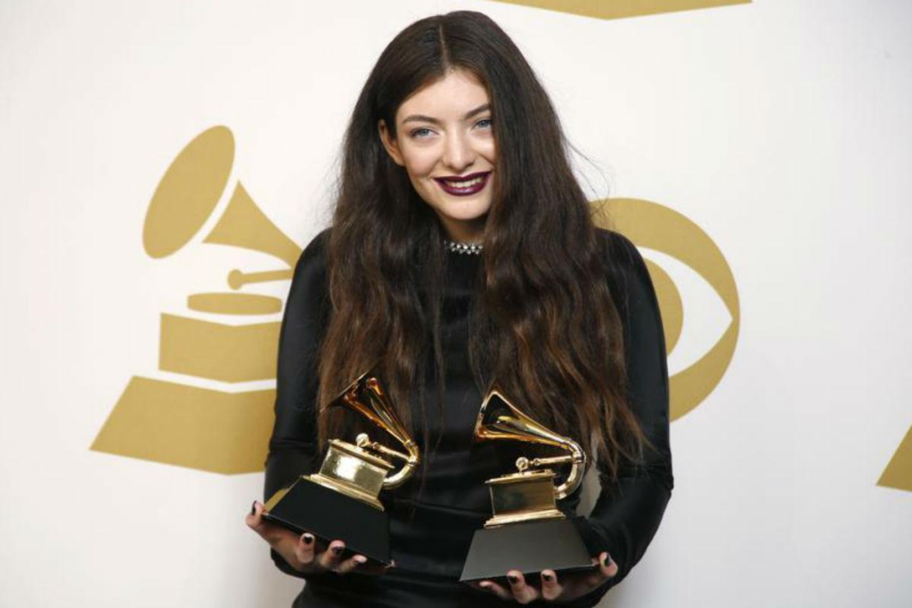 singer Lorde posing with her two Grammy Awards won for the song "Royals" in 2014