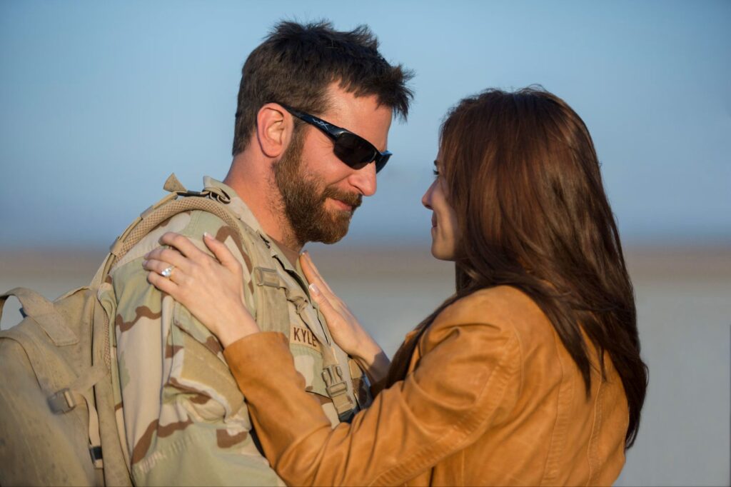 Bradley Cooper and Sienna Miller in a dramatic scene as Chris and Taya Kyle from the 2014 biographical war film American Sniper, which was directed by Clint Eastwood