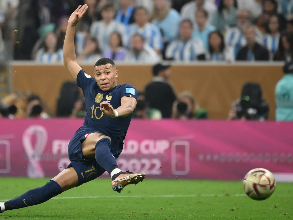 Kylian Mbappé shooting to score for France against Argentina during the 2022 FIFA World Cup final in Qatar