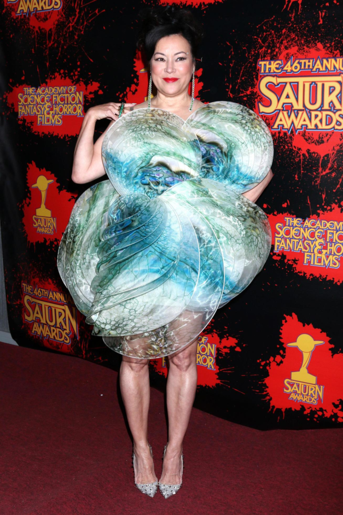 Jennifer Tilly attended the 46th Annual Saturn Awards wearing a blue and green sculptural dress designed to resemble a whirlpool or hurricane
