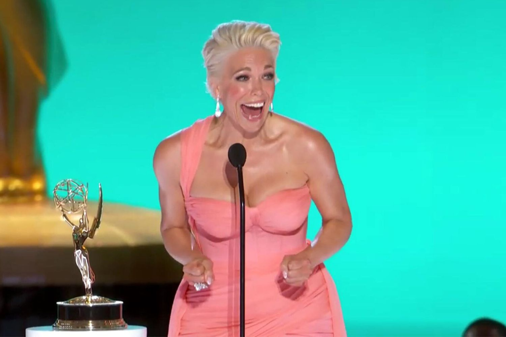 Hannah Waddingham in a pink, one-shoulder corset dress by Christian Siriano while accepting an Emmy Award