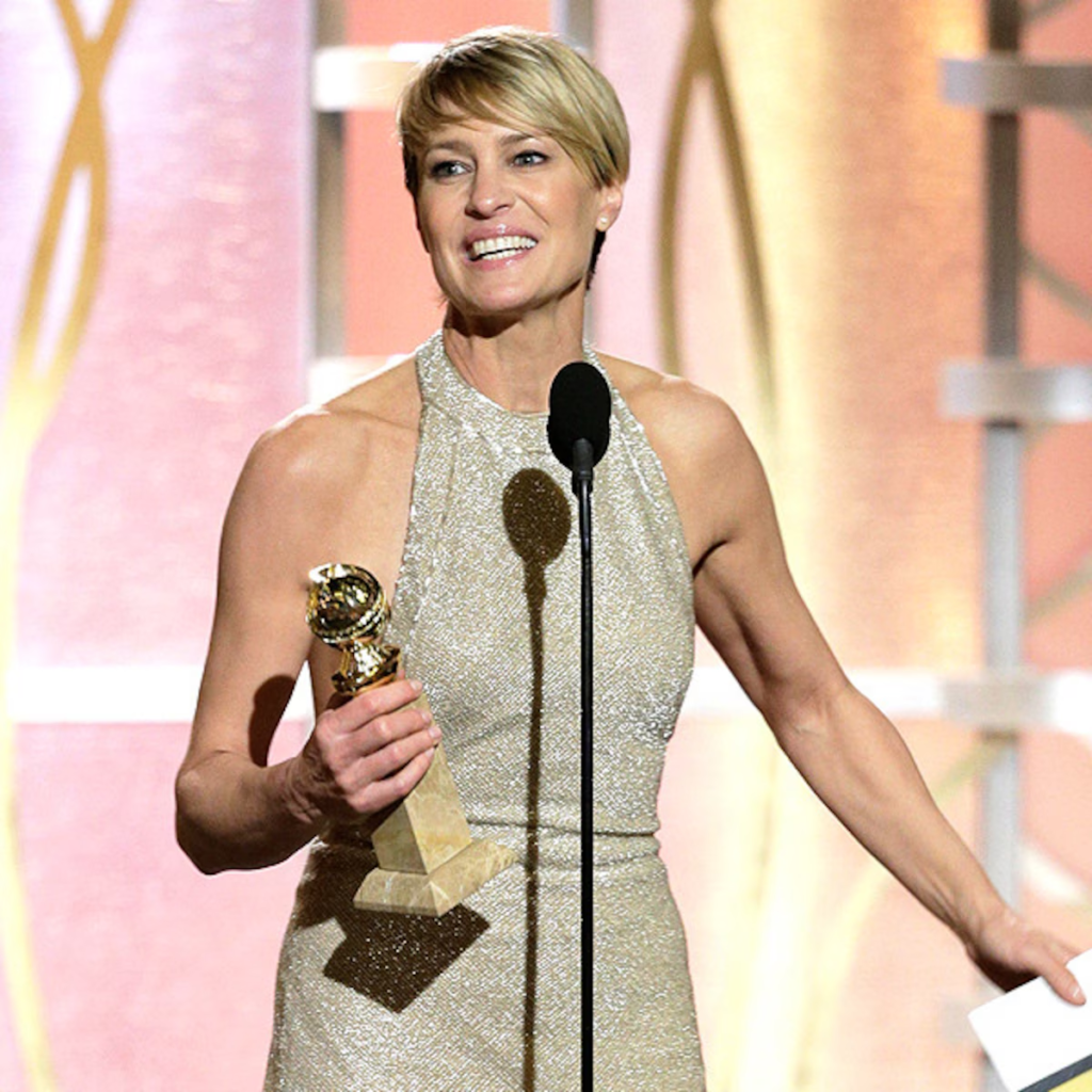 Robin Wright wearing a shimmering nude Reem Acra halter gown while accepting a Golden Globe award