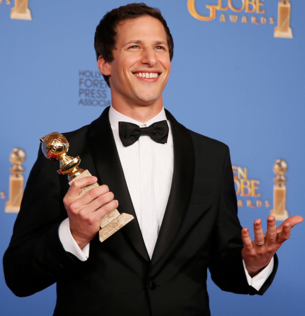 Andy Samberg posing with his 2014 Golden Globe award for Best Actor in a Comedy Series
