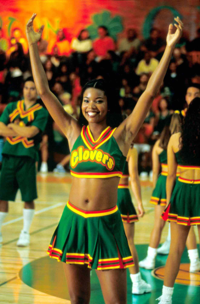 Gabrielle Union plays Isis, the leader of the East Compton Clovers, wearing an iconic green and yellow cheerleading uniform in the 2000 film Bring It On