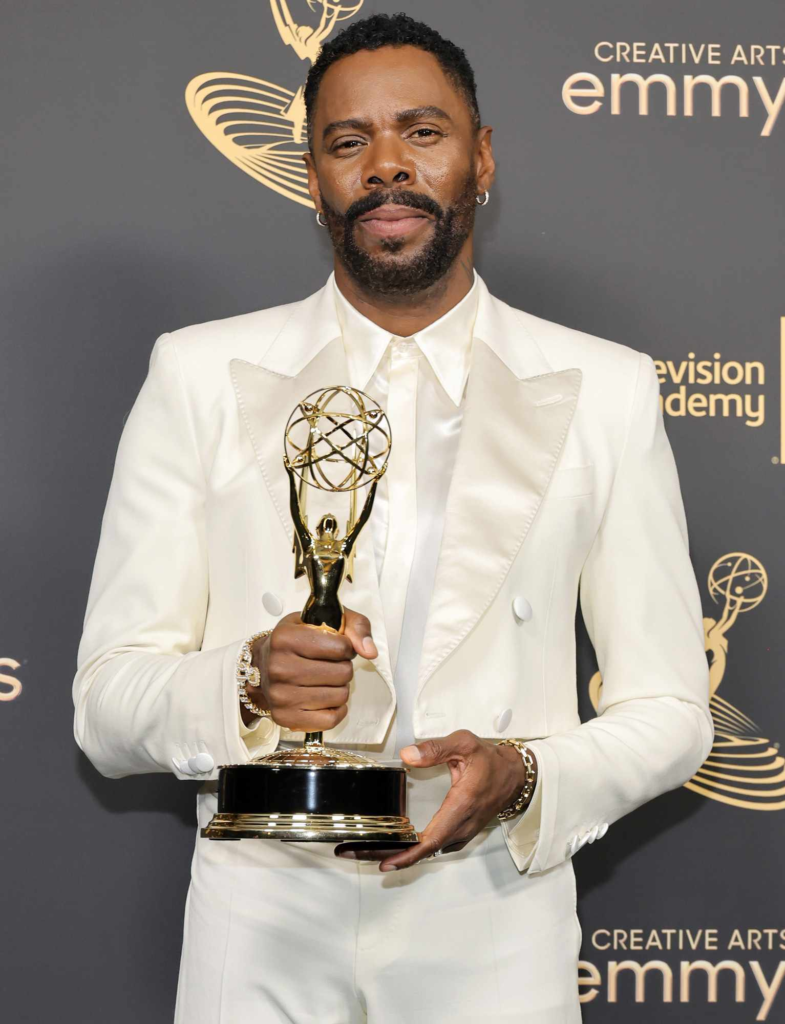 Colman Domingo wears a cream white Valentino suit while holding his first Emmy award for Outstanding Guest Actor in a Drama Series
