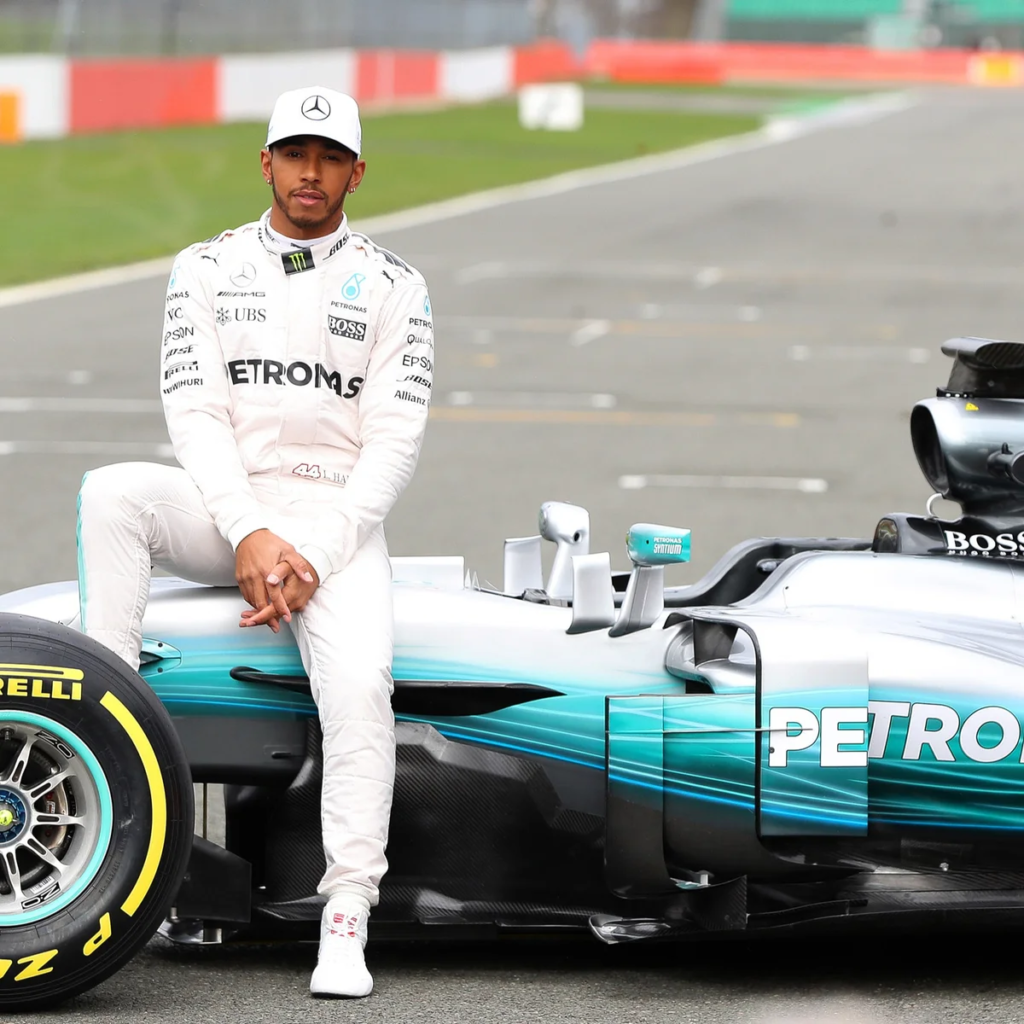 Lewis Hamilton wearing a white racing suit during a Mercedes-AMG F1 team launch