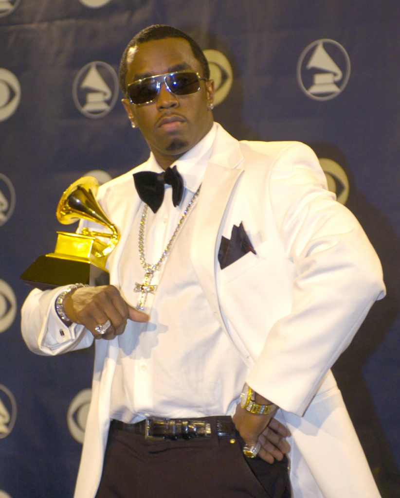 Sean "Diddy" Combs posing backstage with a Grammy award at the 46th Annual Grammy Awards in 2004