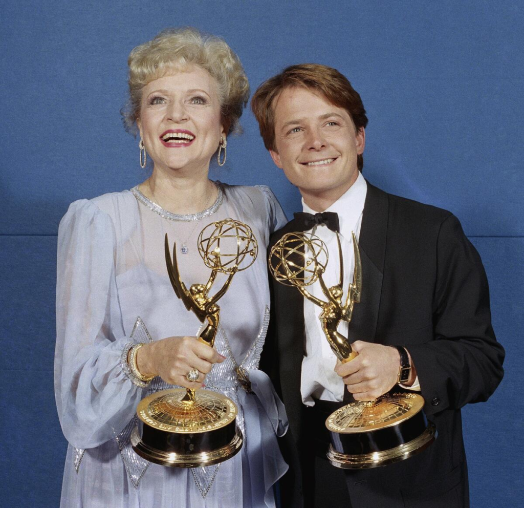 actors Betty White and Michael J. Fox posing backstage with their awards at the 38th Primetime Emmy Awards on September 21, 1986