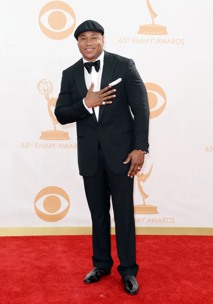 LL Cool J arriving at the 65th Primetime Emmy Awards in a tailored black tuxedo and his signature newsboy cap